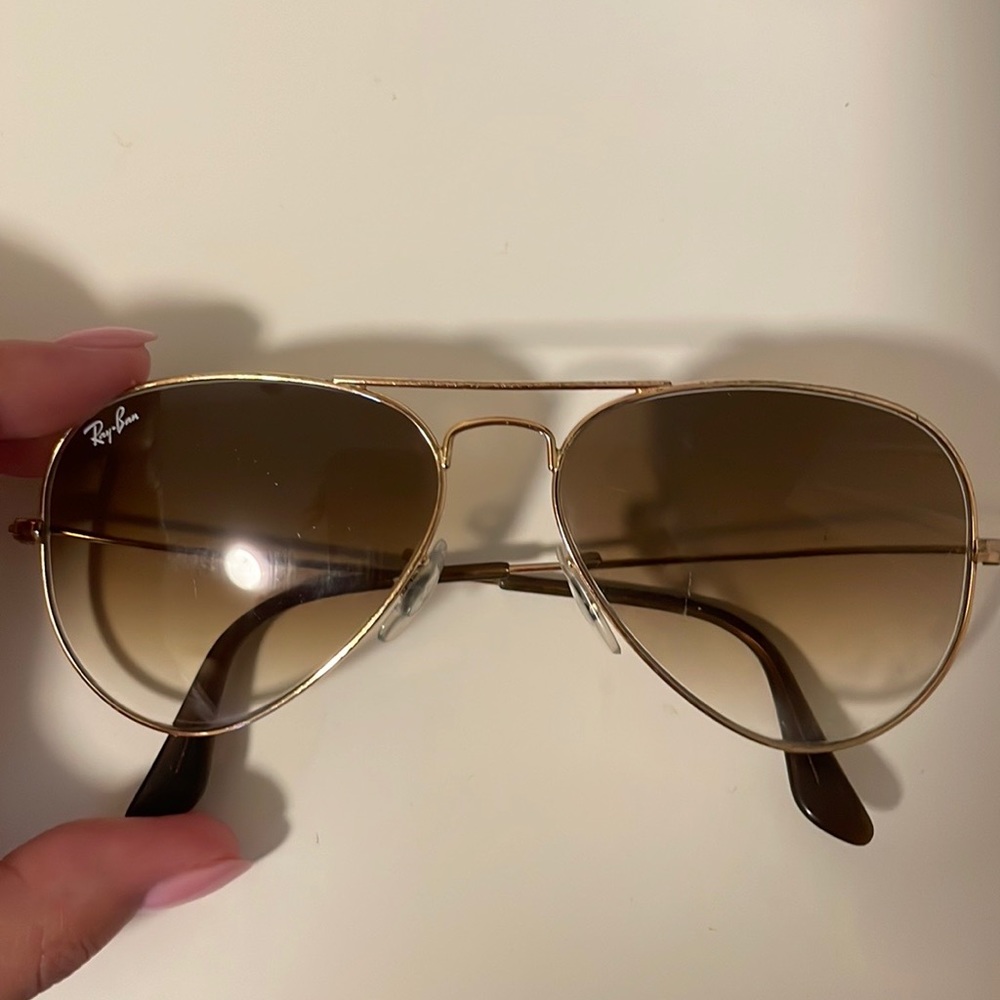 Gold rimmed Raybans with brownish/gold tinted lenses